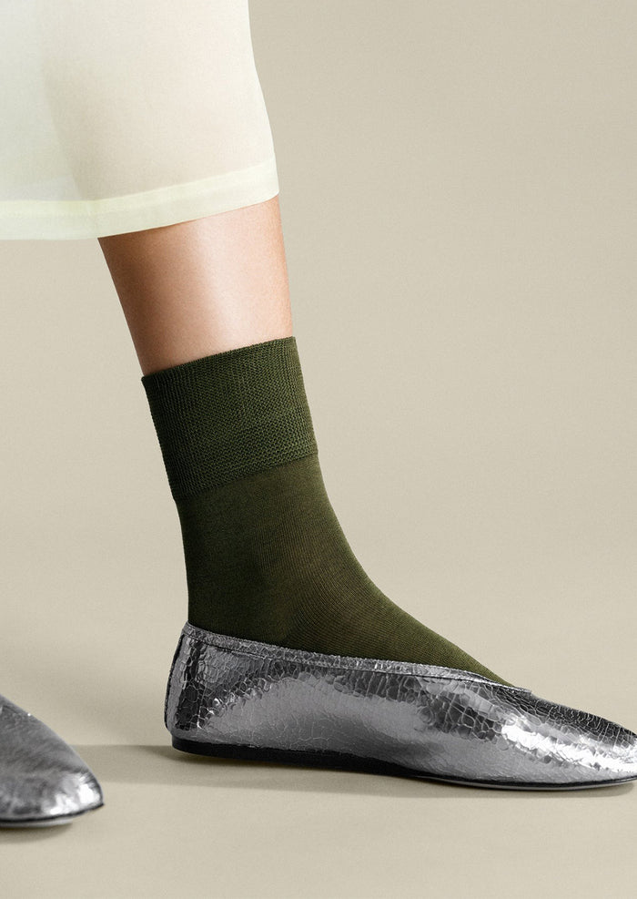 A pair of classic socks in moss green.