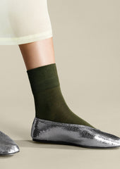 A pair of classic socks in moss green.