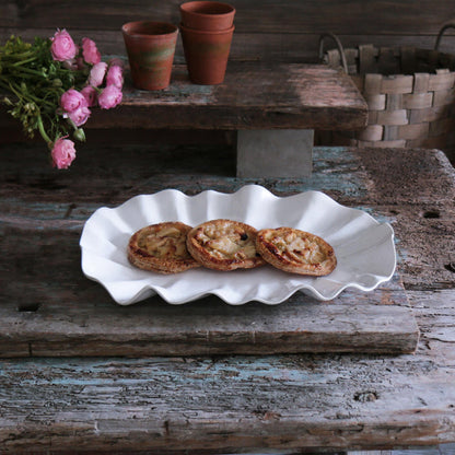 Beatriz Ball Vida Bloom Large Oval Platter — With small pastries on a rustic table